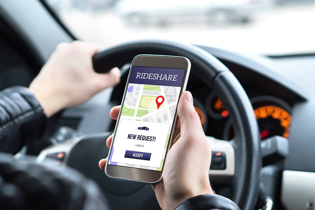 A rideshare car driver checking a new ride request.